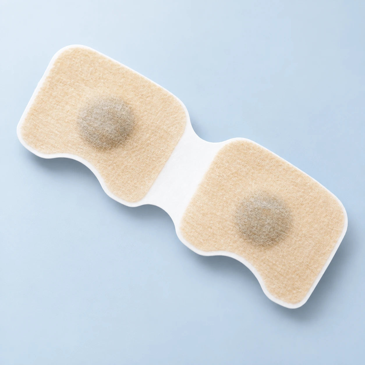Beige refill patches with circular metal disks on white release sheets